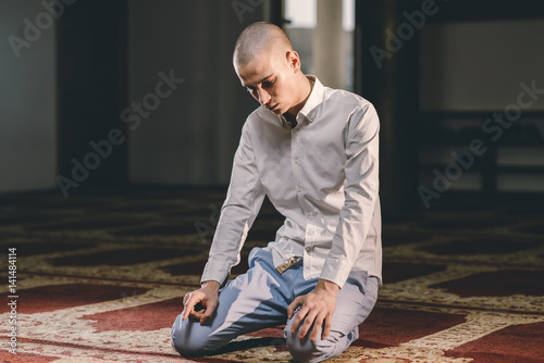 Muslim boy praying in a Mosque