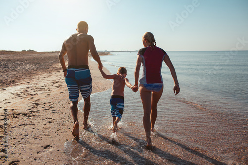 Family on the beach at sunset