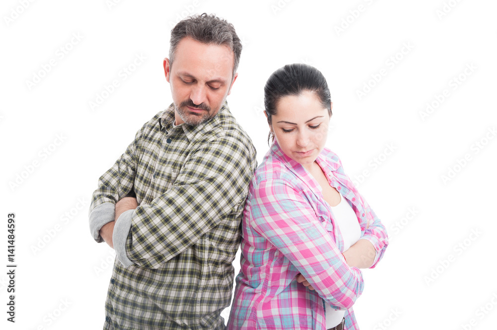 Couple standing to each other with folded arms Couple standing to each other with folded arms
