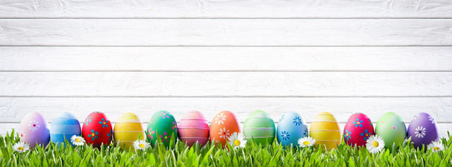 Easter Eggs In A Row And White Wooden Background
