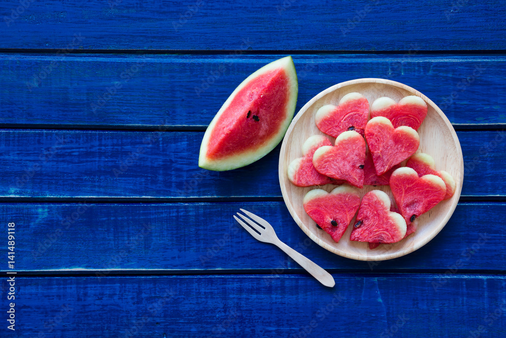 Slices of watermelon on blue rustic wooden table background Slices of watermelon on blue rustic wooden table background