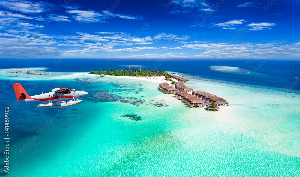 Wasserflugzeug fliegt über Malediven Insel - obrazy, fototapety, plakaty 