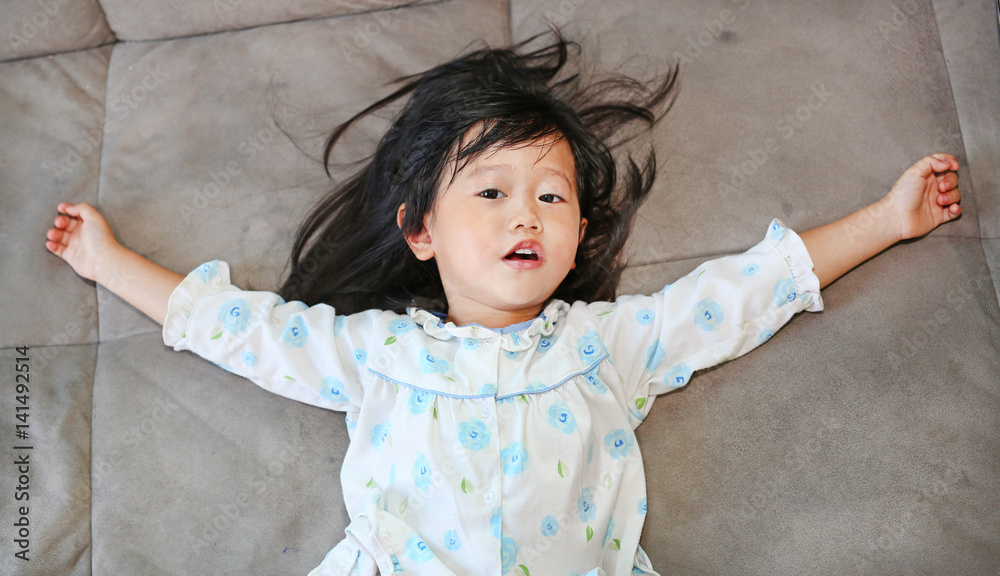 Portrait of cheerful Asian girl on a sofa Portrait of cheerful Asian girl on a sofa