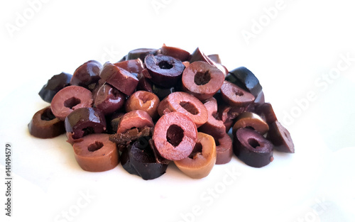 Heap of sliced olives on white photo