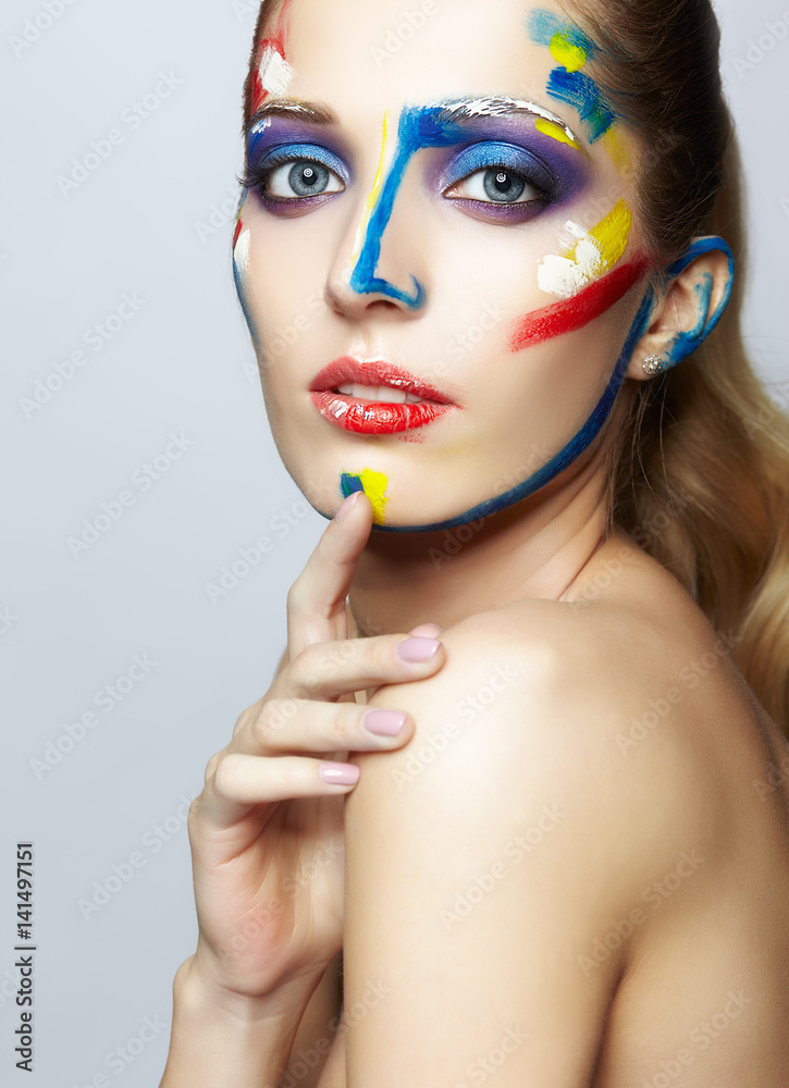 Young female painter with acrylic paint on face Stock Photo Adobe Stock