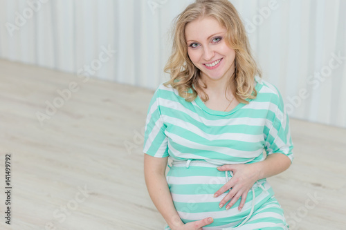 Beautiful pregnant girl waiting for the baby photo