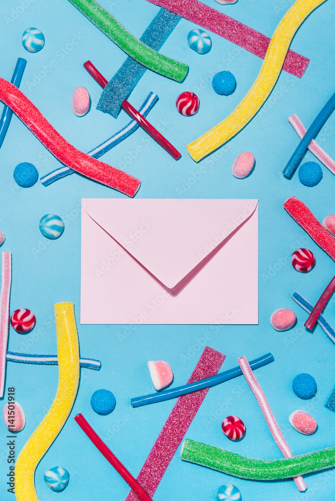 Top view of colorful sugar candies and lollies with envelope Top view of colorful sugar candies and lollies with envelope