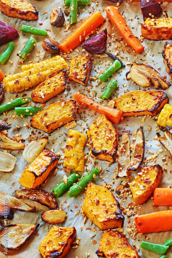 Roasted vegetables (pumpkin, carrot, onion, beetroot, green beans) with spices on a wax paper. Roasted vegetables (pumpkin, carrot, onion, beetroot, green beans) with spices on a wax paper.