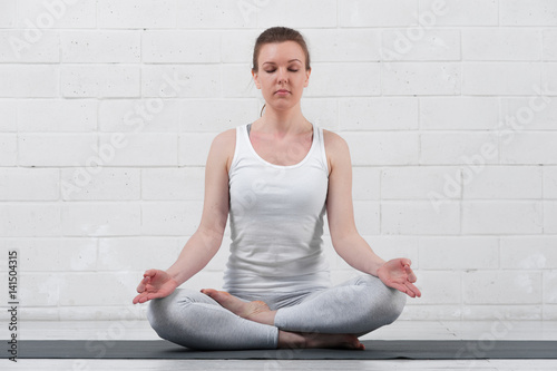 Beautiful young woman doing yoga meditation