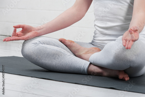 Young woman sitting in yoga meditation pose