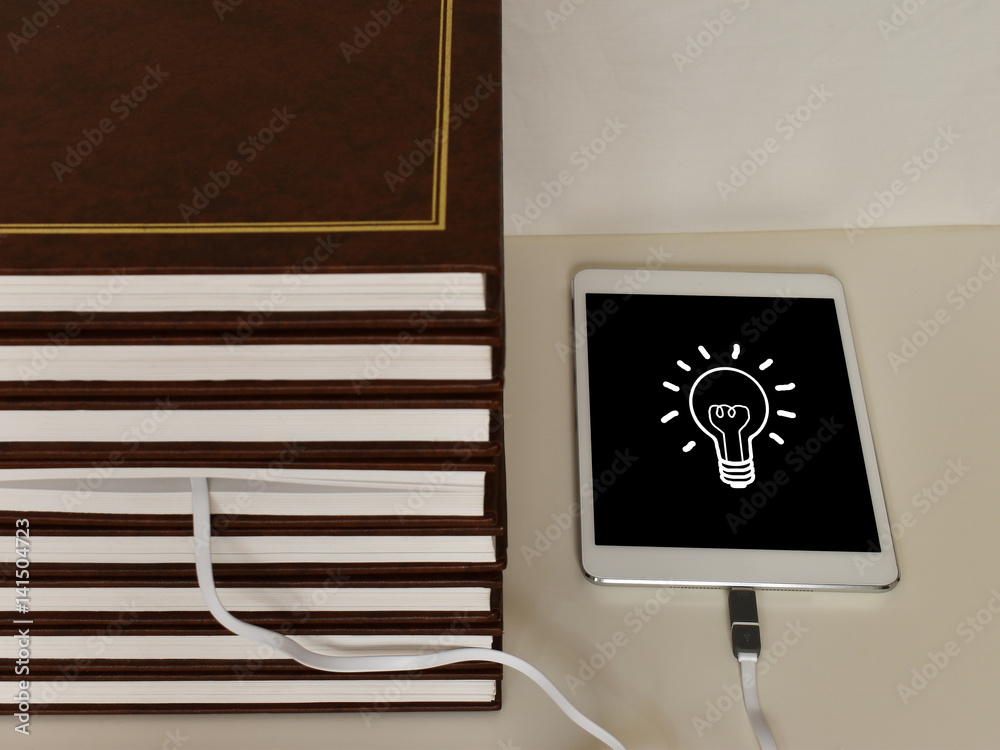 Naklejka premium Book with a tablet