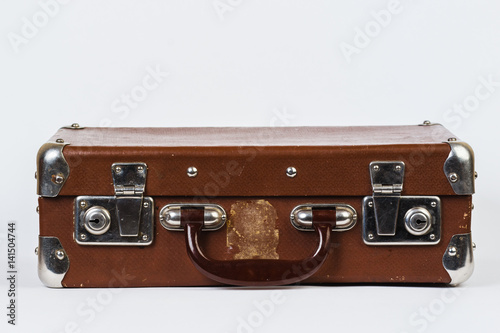 A brown suitcase. Vintage luggage. Vintage travel bag. Isolated on white background.