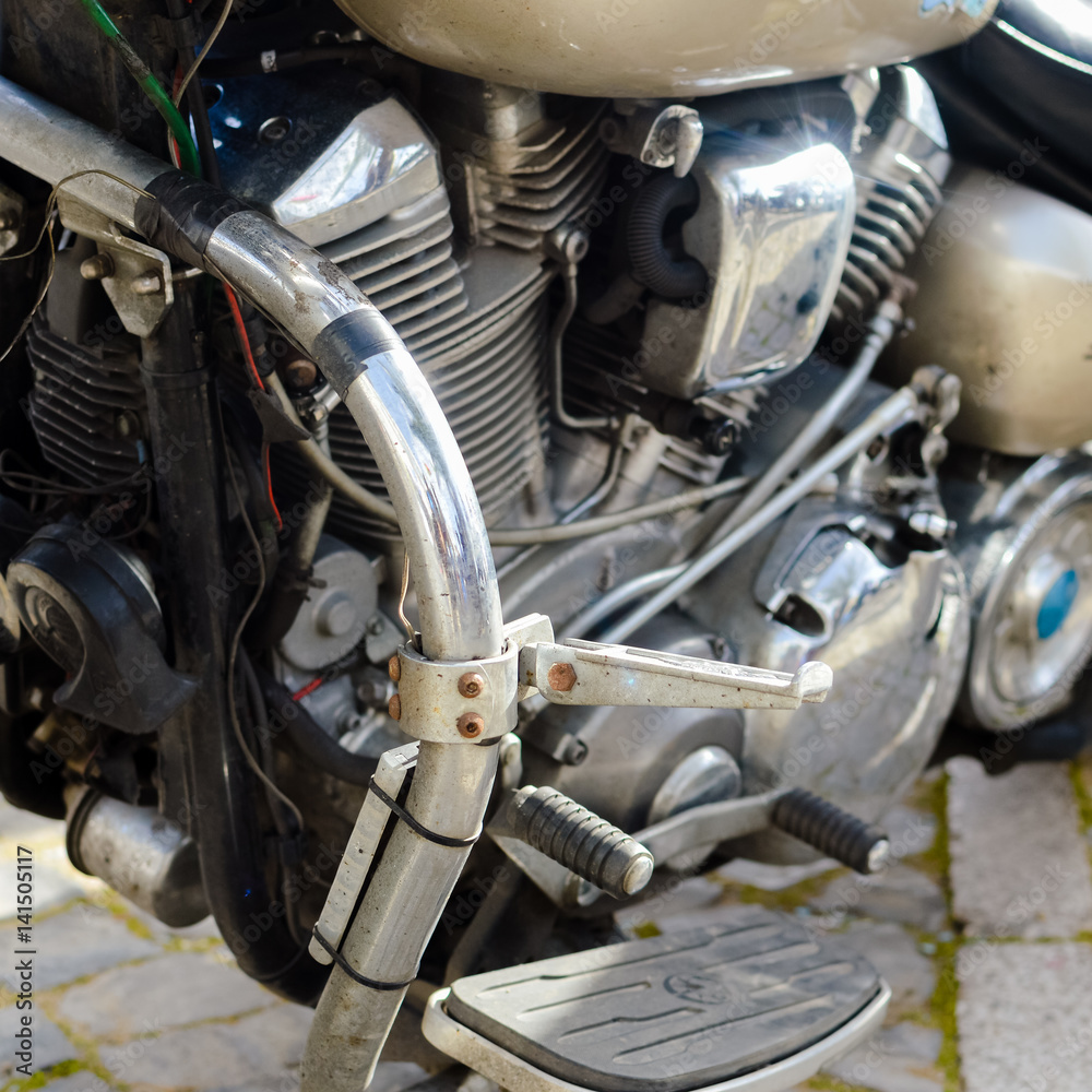 Close up on shiny chrome motorcycle details, silver background Close up on shiny chrome motorcycle details, silver background