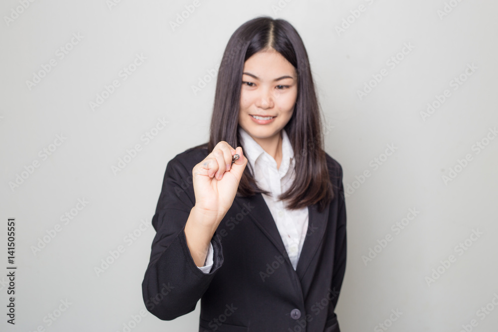 Business women hold pen on white background Business women hold pen on white background