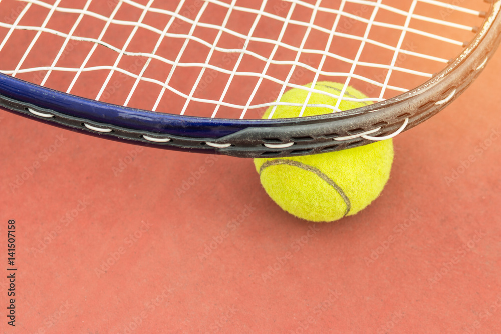 Tennis Ball with Racket on the clay tennis court, top view