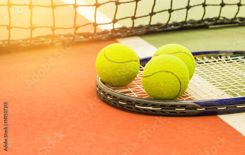 Tennis Ball with Racket on the racket in tennis court © smolaw11