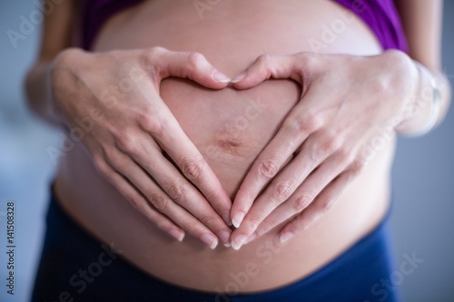 Wallpaper Mural Mid section of pregnant woman touching her belly in ward Torontodigital.ca