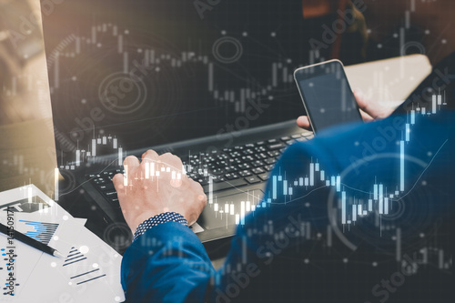 business trading concept : man trade stock and forex by laptop