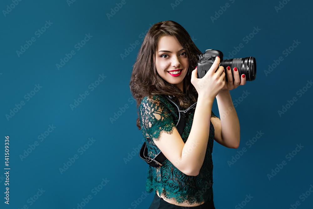 Woman takes images holding photographic camera Woman takes images holding photographic camera