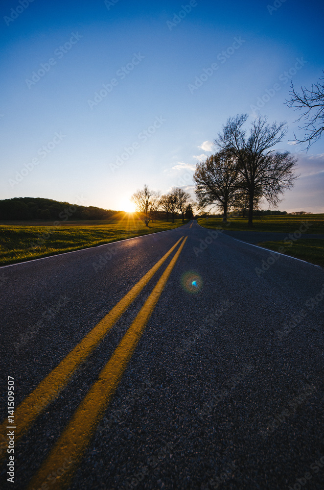 The road and the setting sun