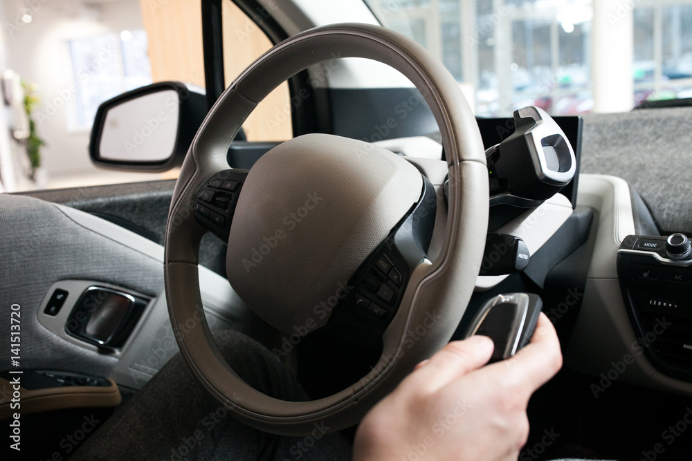 The man's hand on the steering wheel