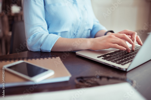 businesswoman using laptop at workplace in office