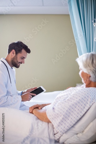 Male doctor discussing medical report 