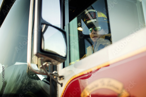 Firefighter driving fire truck