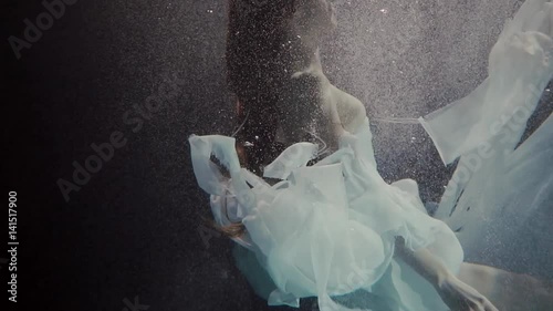 young woman swimming under the water