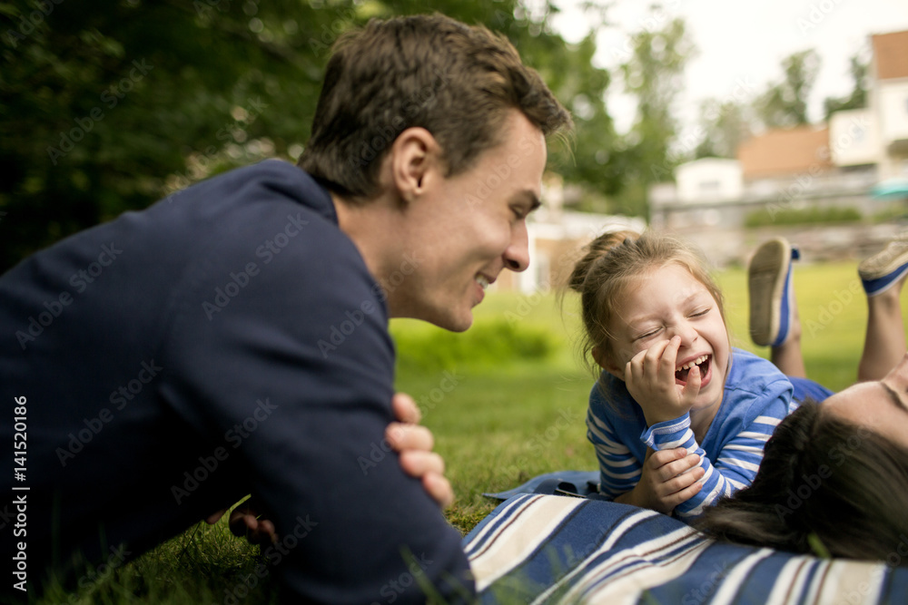 Father laughing with daughter (6-7) in backyard Father laughing with daughter (6-7) in backyard