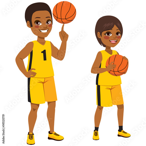 Young basketball African American children players standing with ball