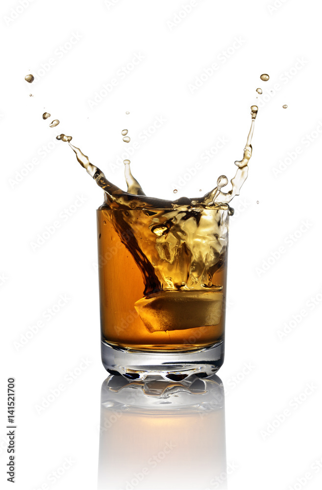 Splash in glass of scotch whiskey with ice Splash in glass of scotch whiskey with ice