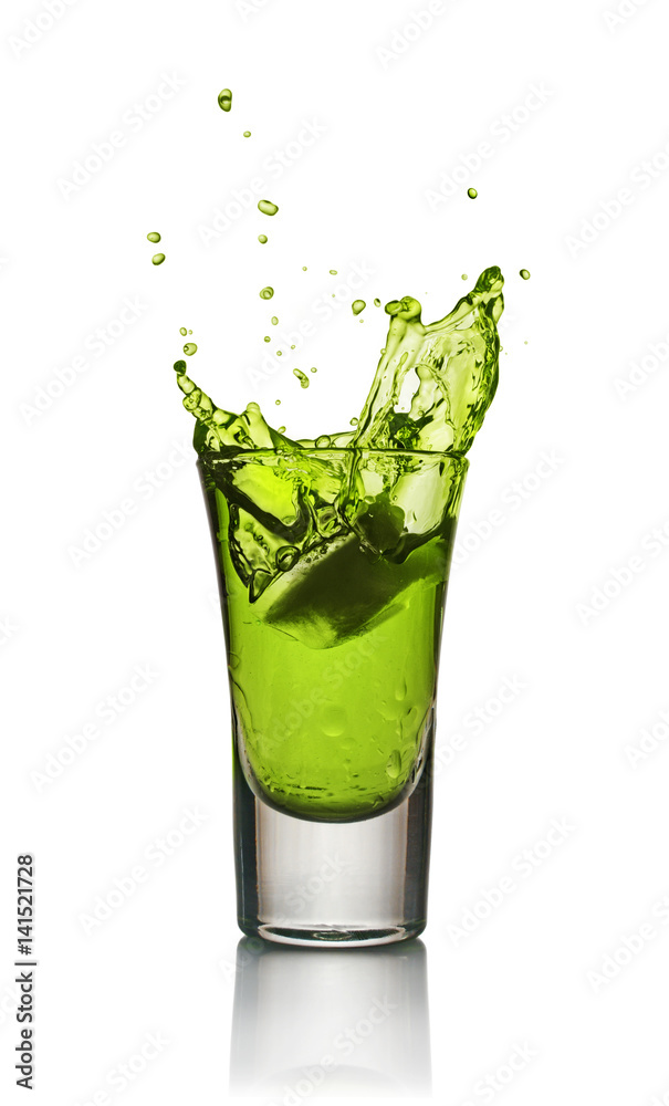 Glass of alcoholic drink with ice. Absinthe or mint liquor shot Glass of alcoholic drink with ice. Absinthe or mint liquor shot