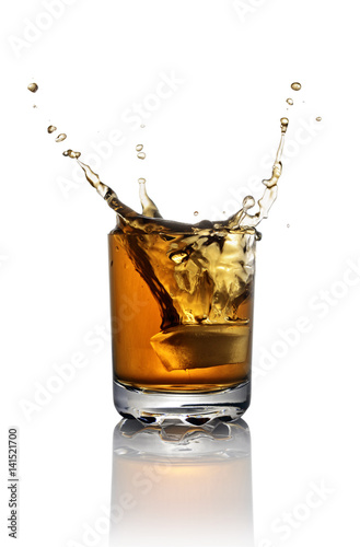 Splash in glass of scotch whiskey with ice
