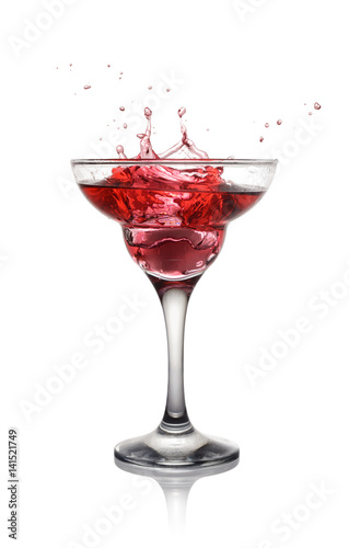 Splash in glass of a pink alcoholic cocktail drink