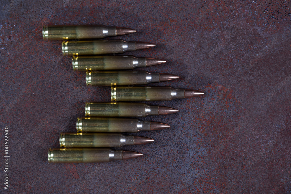 Group of ammunition on a rusted metal background Group of ammunition on a rusted metal background