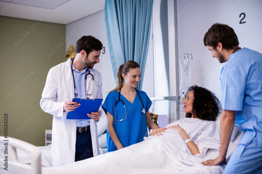 Fototapeta premium Team of doctors interacting with the pregnant woman