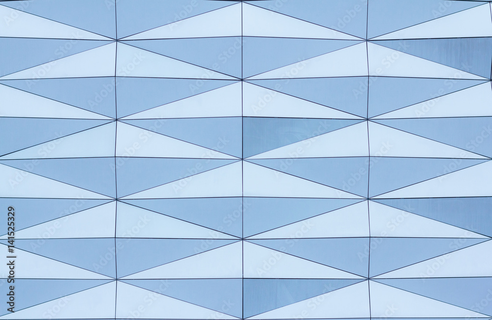 Geometric pattern with big blue triangle panels. Modern building facade Geometric pattern with big blue triangle panels. Modern building facade