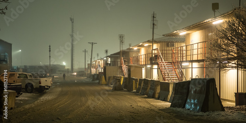 Quadro su tela Barracks on military installation in Afghanistan during snow in winter at Night