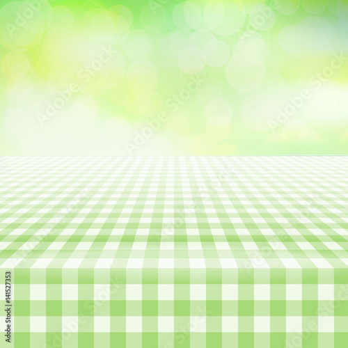 Empty picnic gingham tablecloth, green background