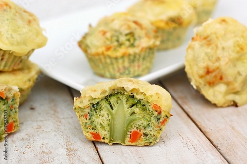 Vegetable muffin with broccoli, carrot, egg and cheese on wooden background