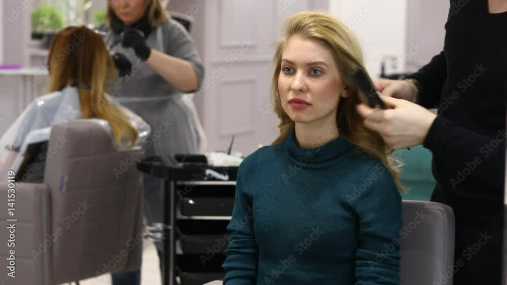 Styling hair in the beauty salon. Young beautiful blonde model in a hairdresser Styling hair in the beauty salon. Young beautiful blonde model in a hairdresser