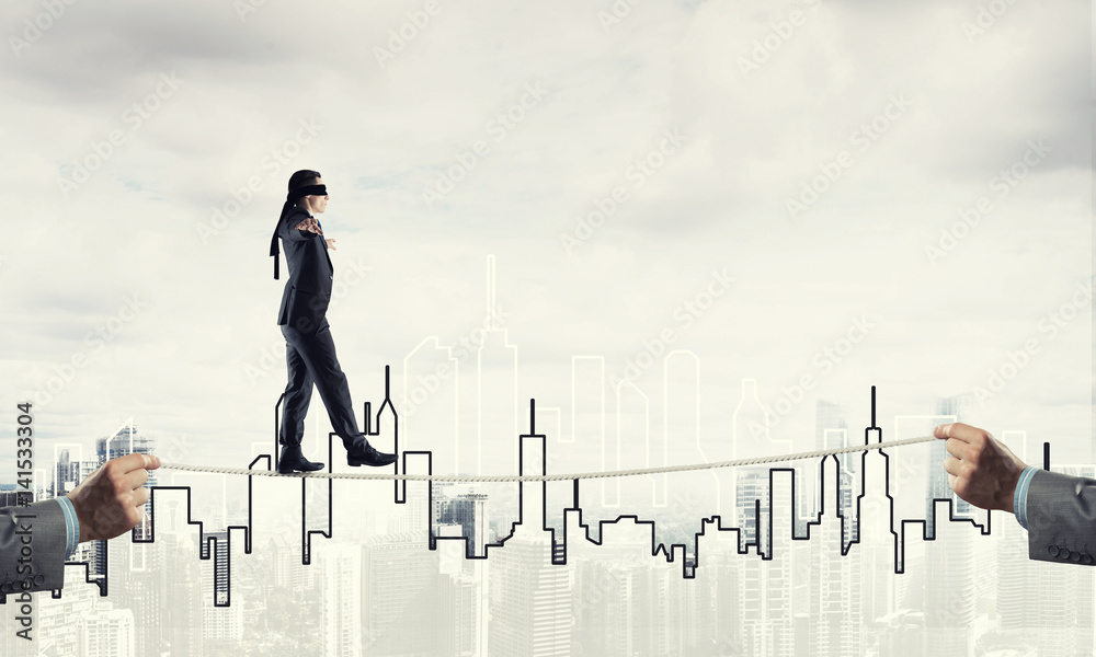 Business concept of risk support and assistance with man balancing on rope Business concept of risk support and assistance with man balancing on rope
