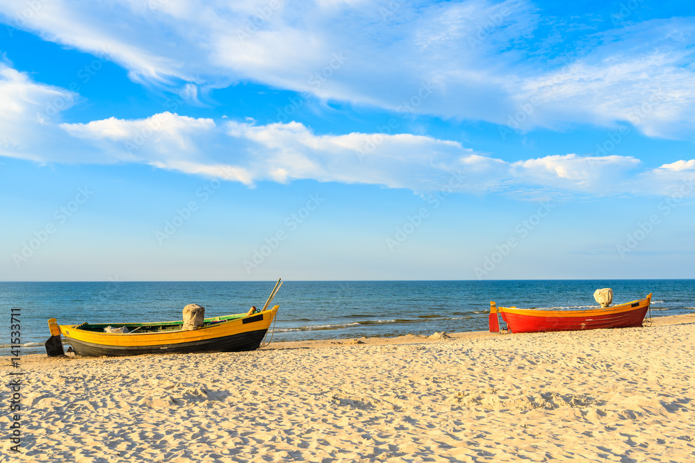 Fototapeta premium Colorful fishing boats on sandy Debki beach during sunny summer day, Baltic Sea, Poland