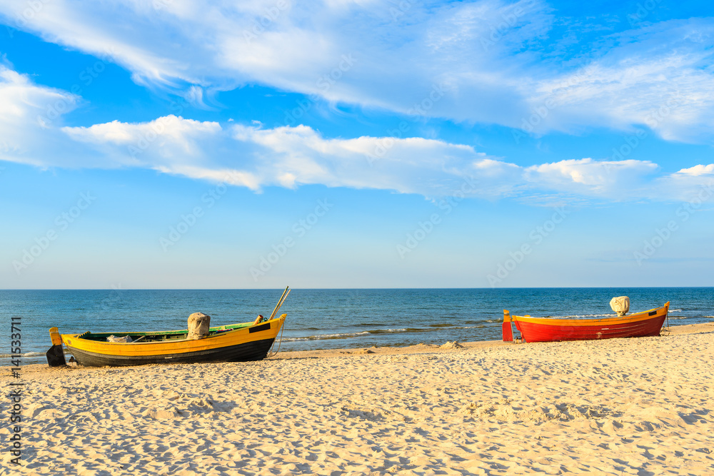 Colorful fishing boats on sandy Debki beach during sunny summer day, Baltic Sea, Poland