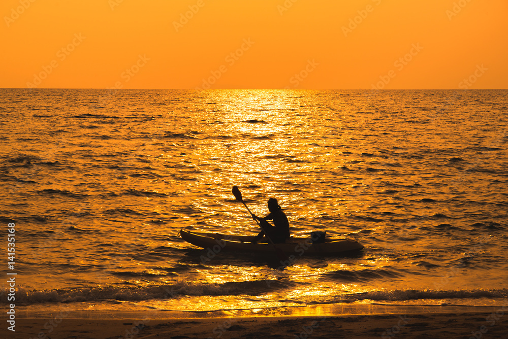 fisherman are boating on sea in sunset