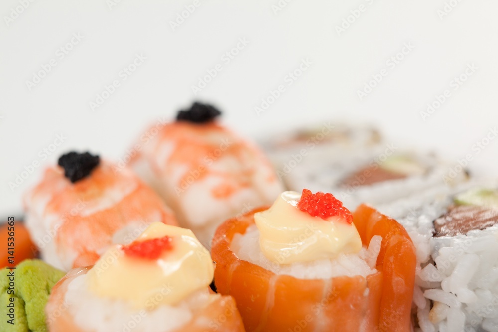 Uramaki and nigiri sushi served on wooden board Uramaki and nigiri sushi served on wooden board