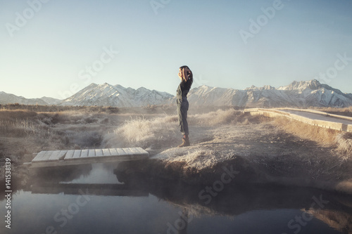 Woman relaxing by hot spring photo