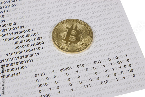 gold bitcoin on the background of binary code