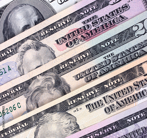 American dollar bills of different denominations abstract background.